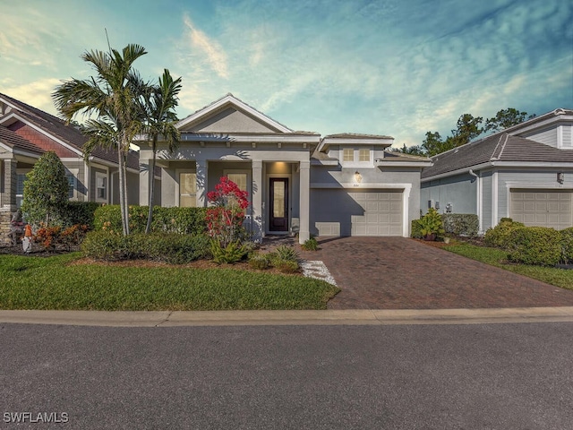 view of front facade featuring decorative driveway, an attached garage, and stucco siding