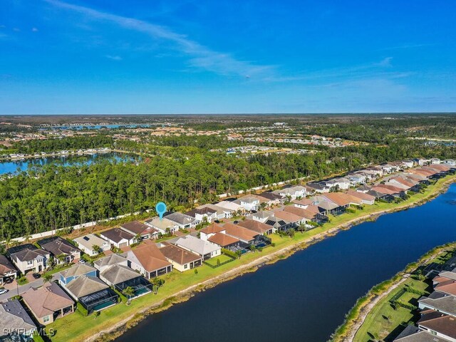 drone / aerial view featuring a water view and a residential view