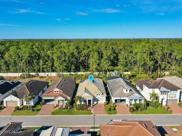 birds eye view of property with a residential view and a view of trees