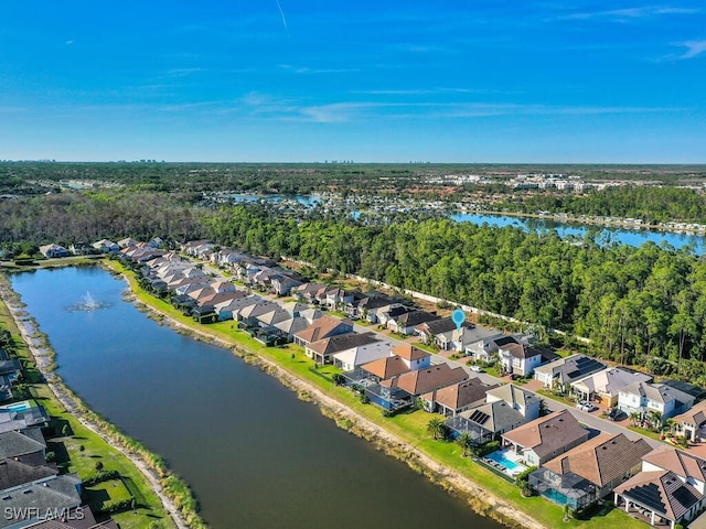 drone / aerial view with a residential view and a water view