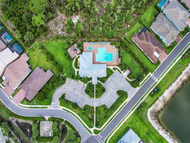 birds eye view of property with a water view and a residential view