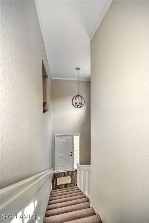 stairway featuring crown molding