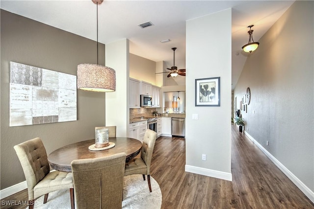 dining room with hardwood / wood-style floors and ceiling fan