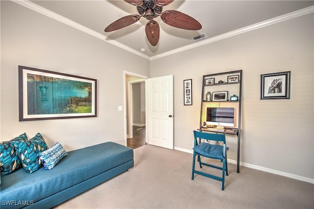 sitting room with ceiling fan, carpet floors, and crown molding