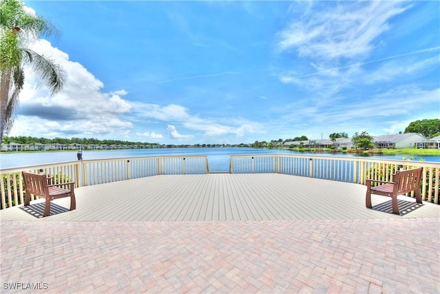 wooden terrace featuring a water view