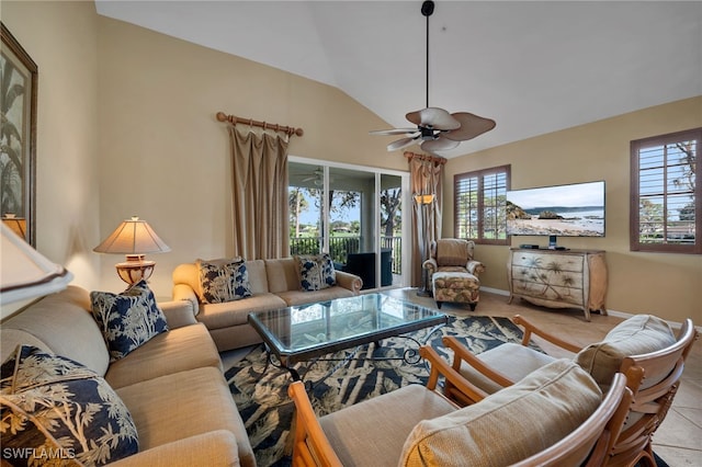 living room with ceiling fan, lofted ceiling, and light tile patterned flooring