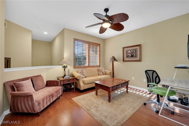 living room with light hardwood / wood-style floors and ceiling fan