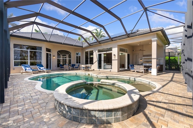 view of swimming pool with an in ground hot tub, a patio area, glass enclosure, and ceiling fan