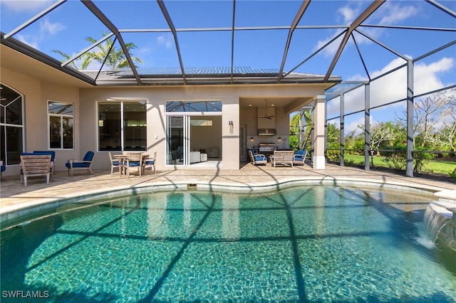 view of pool with a lanai, ceiling fan, and a patio area