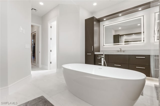 bathroom featuring a bath and vanity