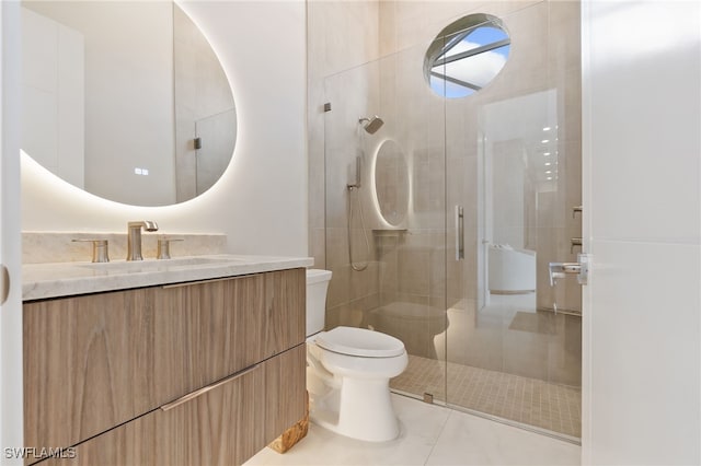 bathroom featuring a shower with shower door, toilet, vanity, and tile patterned flooring