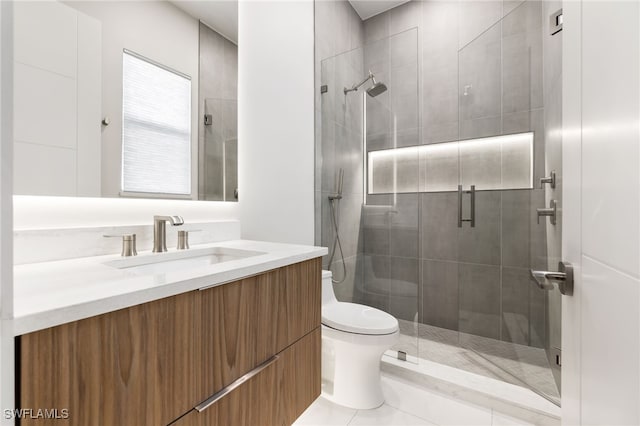 bathroom with toilet, tile patterned flooring, a shower with shower door, and vanity