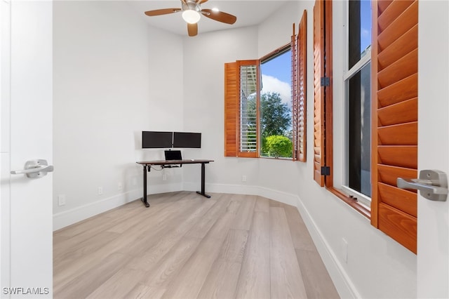 unfurnished office featuring ceiling fan and light hardwood / wood-style floors