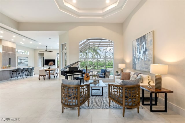 living room featuring ceiling fan and light tile patterned floors