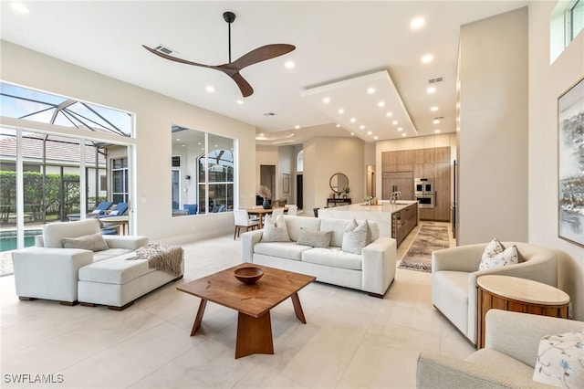 tiled living room featuring ceiling fan