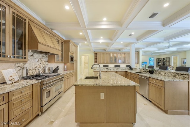 kitchen featuring visible vents, a spacious island, glass insert cabinets, stainless steel appliances, and a sink