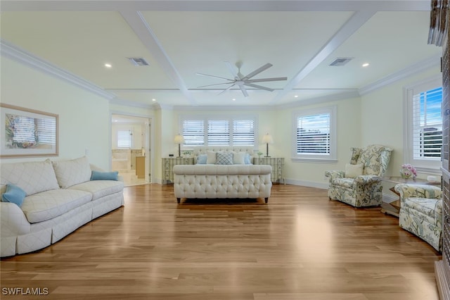 living room featuring a healthy amount of sunlight, light wood-style flooring, and visible vents