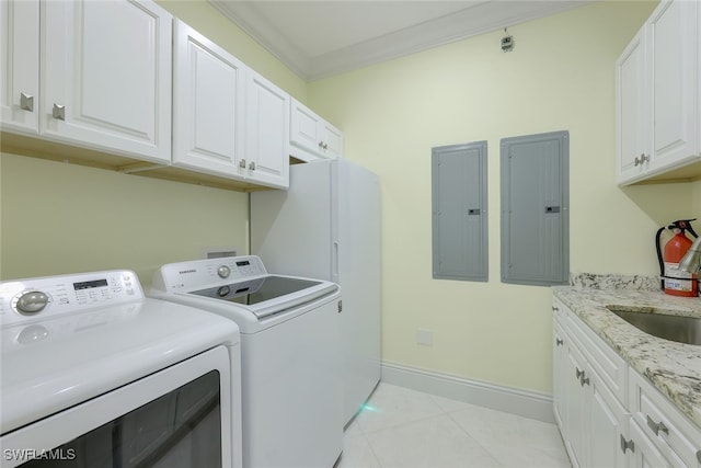 laundry room with baseboards, electric panel, cabinet space, and washing machine and clothes dryer