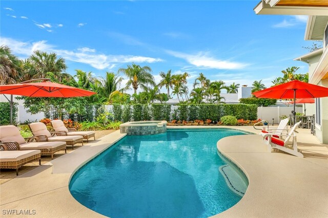 view of pool featuring an in ground hot tub and a patio