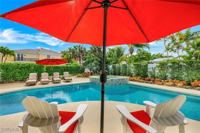 view of swimming pool with a pool with connected hot tub, a fenced backyard, and a patio