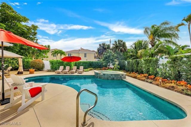 view of swimming pool with a patio area, a fenced backyard, and a pool with connected hot tub