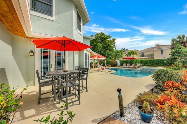 view of swimming pool featuring a patio, outdoor dining area, and a fenced in pool