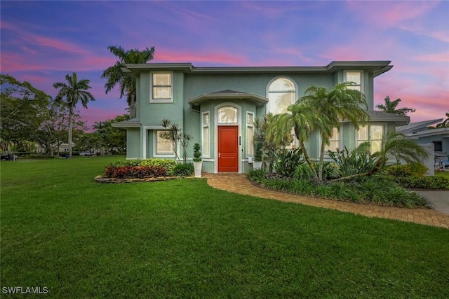 view of front of house featuring a front yard and stucco siding