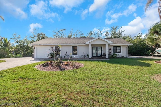 ranch-style home with a front yard, french doors, and a garage