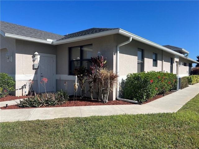 view of property exterior featuring a garage and a lawn