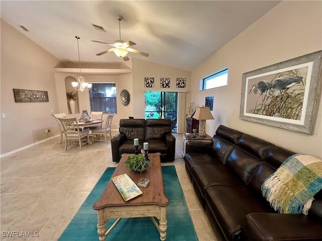 tiled living room featuring ceiling fan with notable chandelier and lofted ceiling