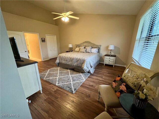 bedroom with vaulted ceiling, ceiling fan, and dark wood-type flooring