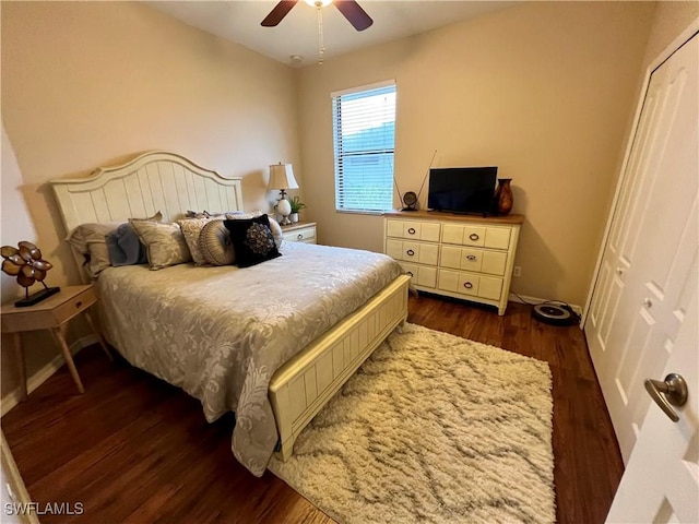 bedroom with dark hardwood / wood-style floors, ceiling fan, and a closet