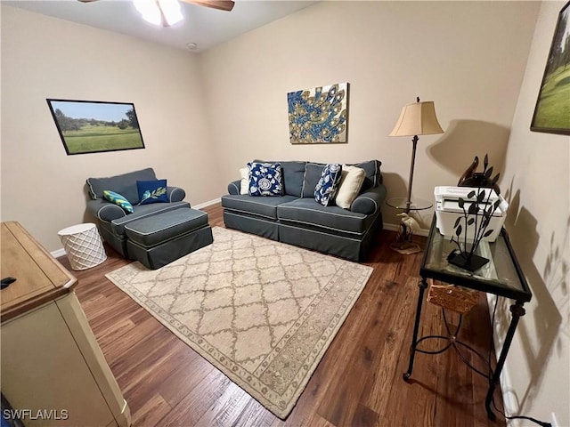 living room with ceiling fan and dark hardwood / wood-style flooring