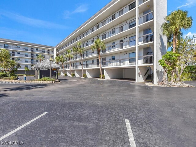995 Anglers Cv Unit N201, Marco Island, FL 34145 - view of apartment building / complex with uncovered parking