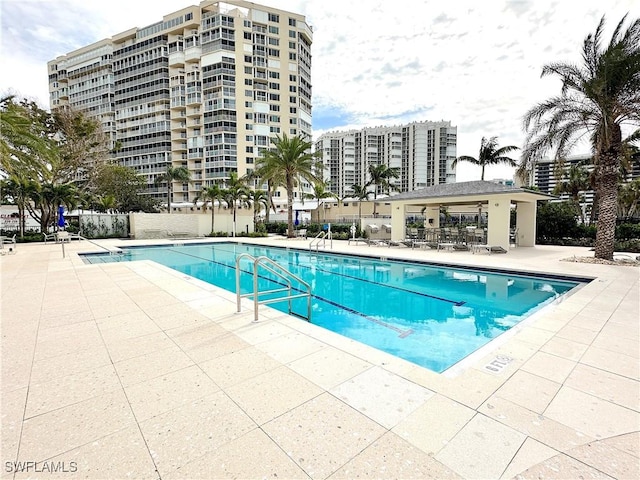 community pool featuring a patio area and fence