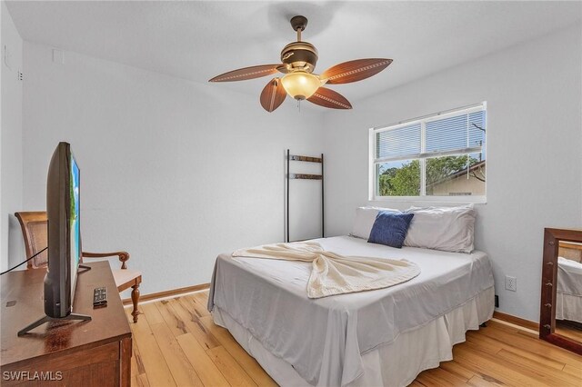 bedroom with ceiling fan and light wood-type flooring