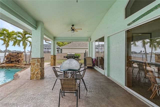 view of patio featuring ceiling fan, a fenced in pool, and grilling area