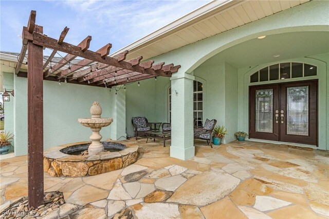 view of patio / terrace with a pergola and french doors