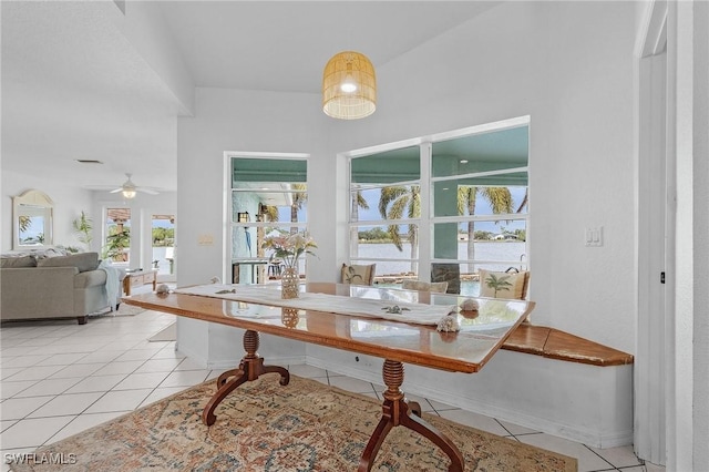 dining space featuring light tile patterned floors and ceiling fan