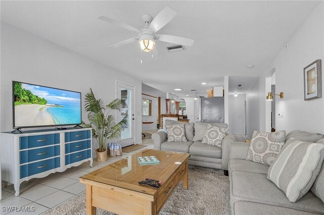 tiled living room featuring ceiling fan