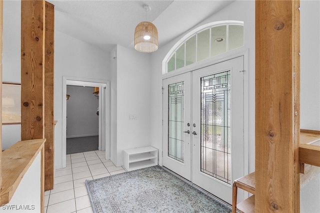 tiled entrance foyer featuring french doors