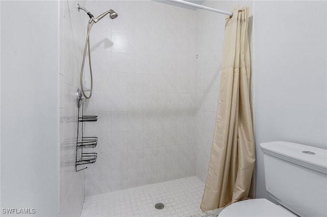 bathroom with toilet and curtained shower