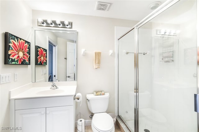 bathroom with vanity, an enclosed shower, and toilet