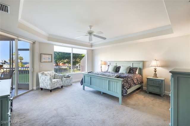 bedroom with carpet, access to outside, ceiling fan, ornamental molding, and a tray ceiling