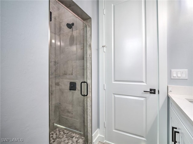 bathroom featuring vanity and a shower with shower door