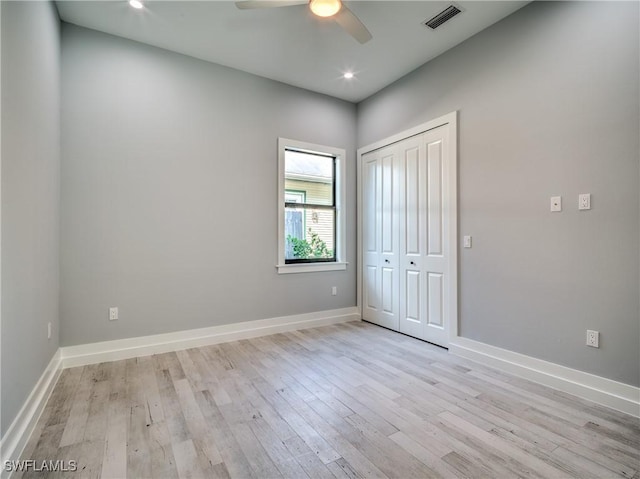 unfurnished bedroom featuring a closet, light hardwood / wood-style floors, and ceiling fan