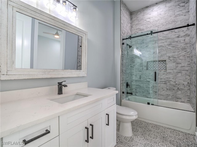 full bathroom with vanity, ceiling fan, toilet, and bath / shower combo with glass door