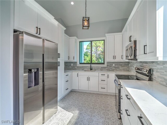 19871 Adams Rd, Fort Myers, FL 33908 - kitchen with tasteful backsplash, a sink, appliances with stainless steel finishes, white cabinetry, and light stone counters