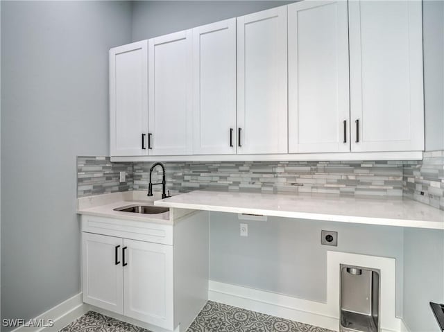 19871 Adams Rd, Fort Myers, FL 33908 - clothes washing area featuring baseboards, hookup for an electric dryer, a sink, and cabinet space