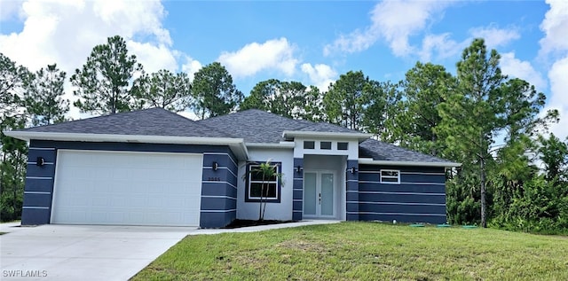 prairie-style house with a garage and a front lawn